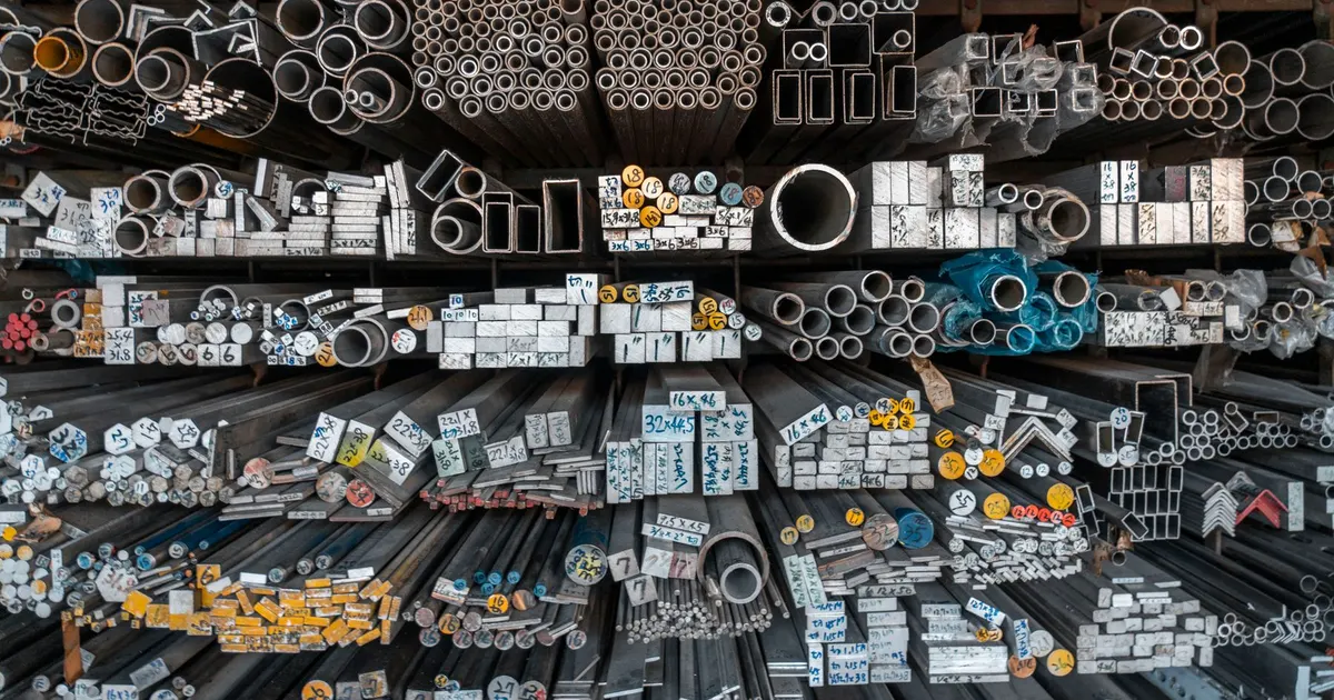 Racks of metal bars, tubes and profiles stored in a stockholding warehouse